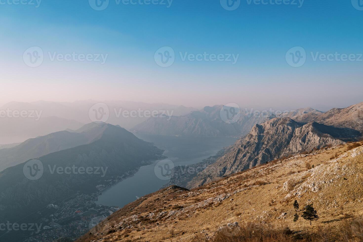 View from the mountain to the valley of the Bay of Kotor and mountains in the fog photo