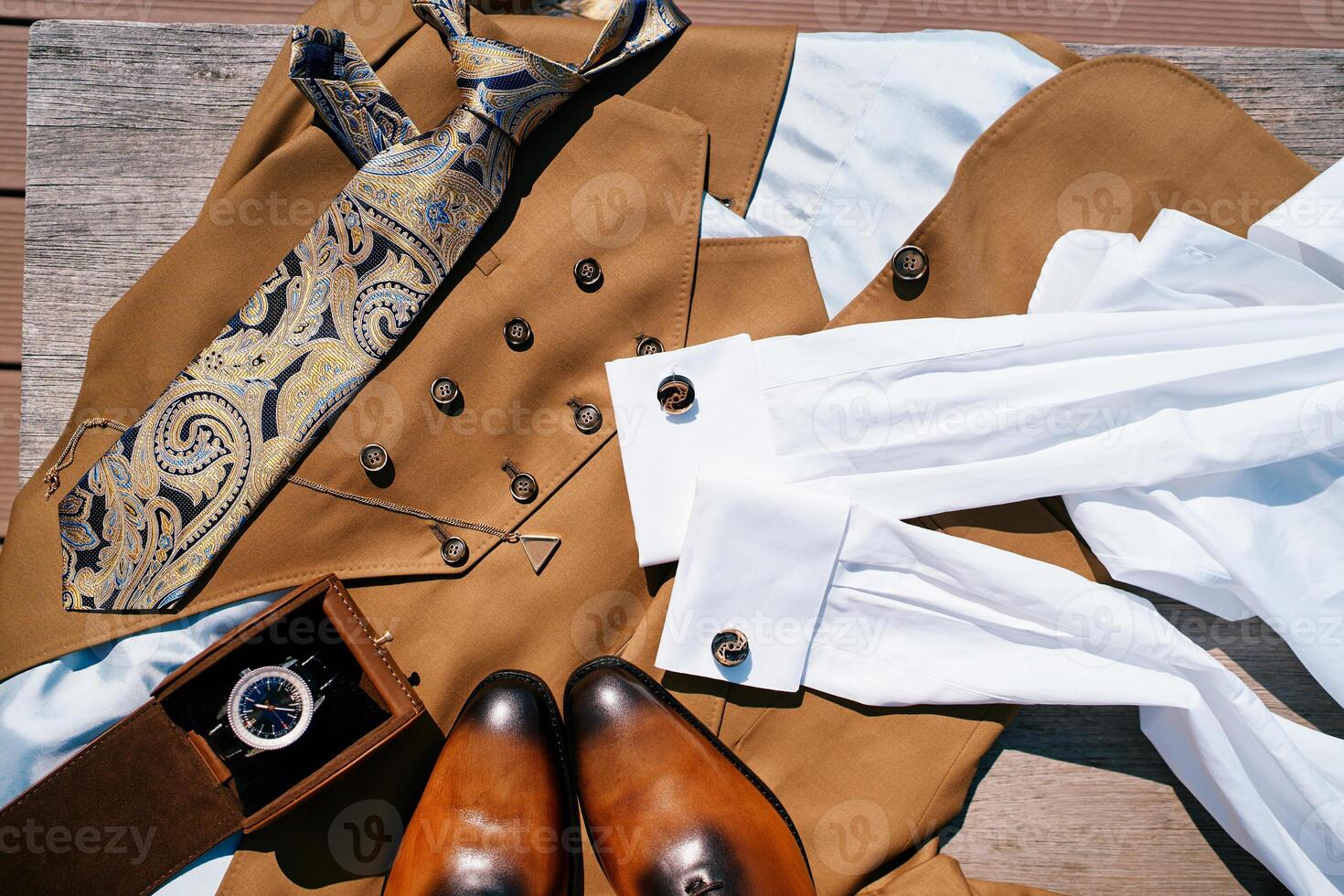 Man watch in a box lies on the groom suit next to his shoes photo