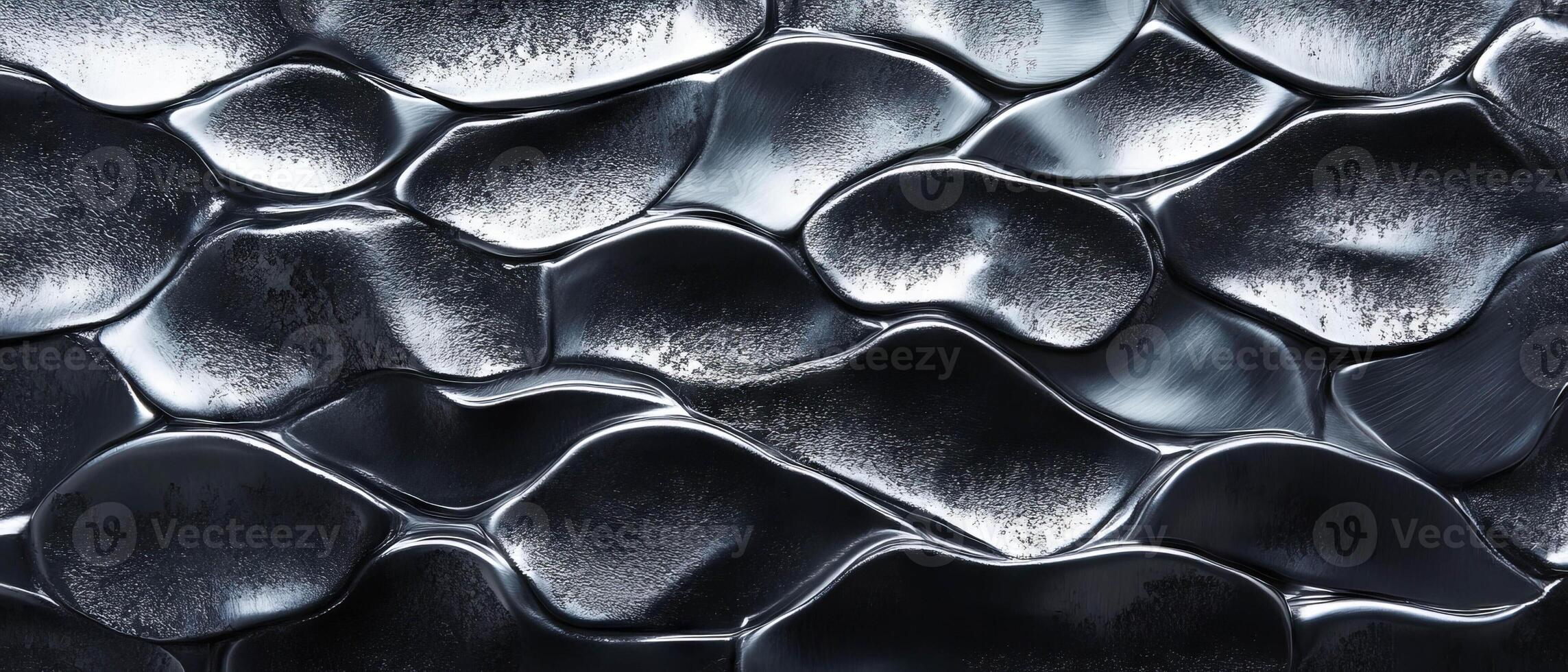 Hammered aluminum displays a unique textured surface with irregular, flowing patterns and shine. photo