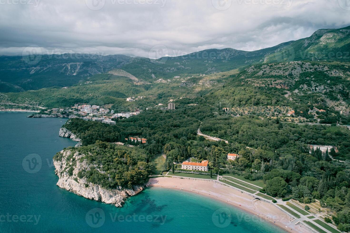 Beach and green park near Villa Milocer at the foot of the mountains. Montenegro. Top view photo