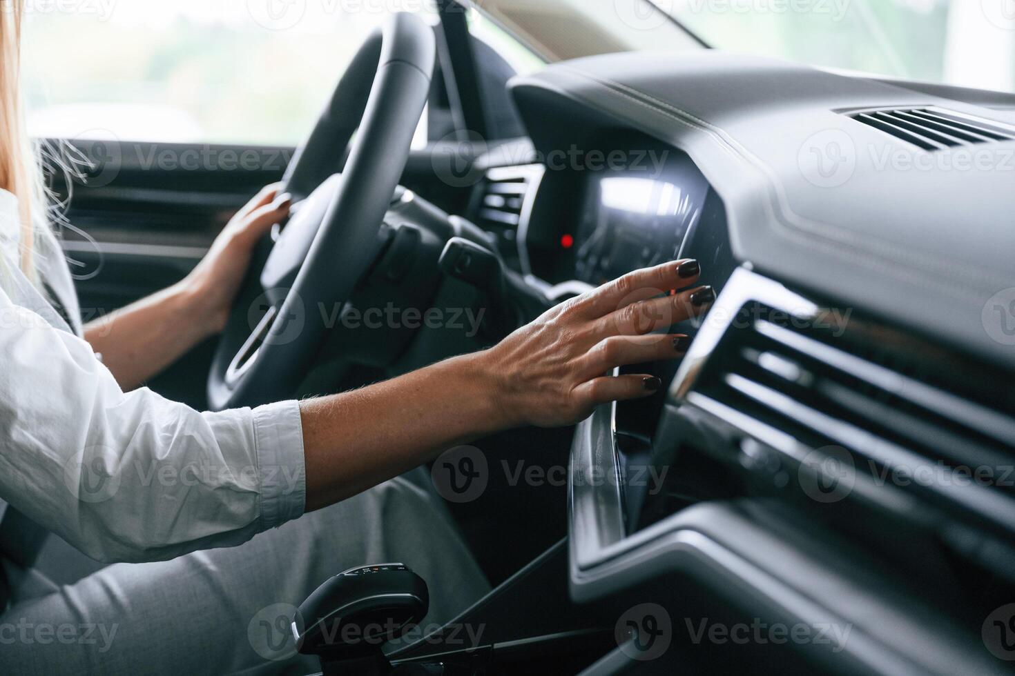 Close up view.. Woman is sitting in a car and driving it photo