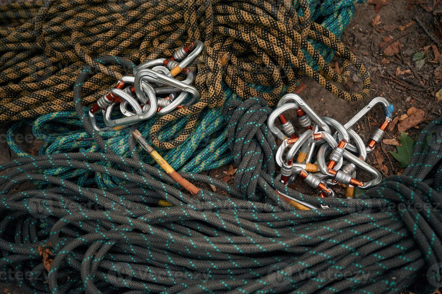 Bunch of ropes and carabiners are on the ground, conception of climbing photo