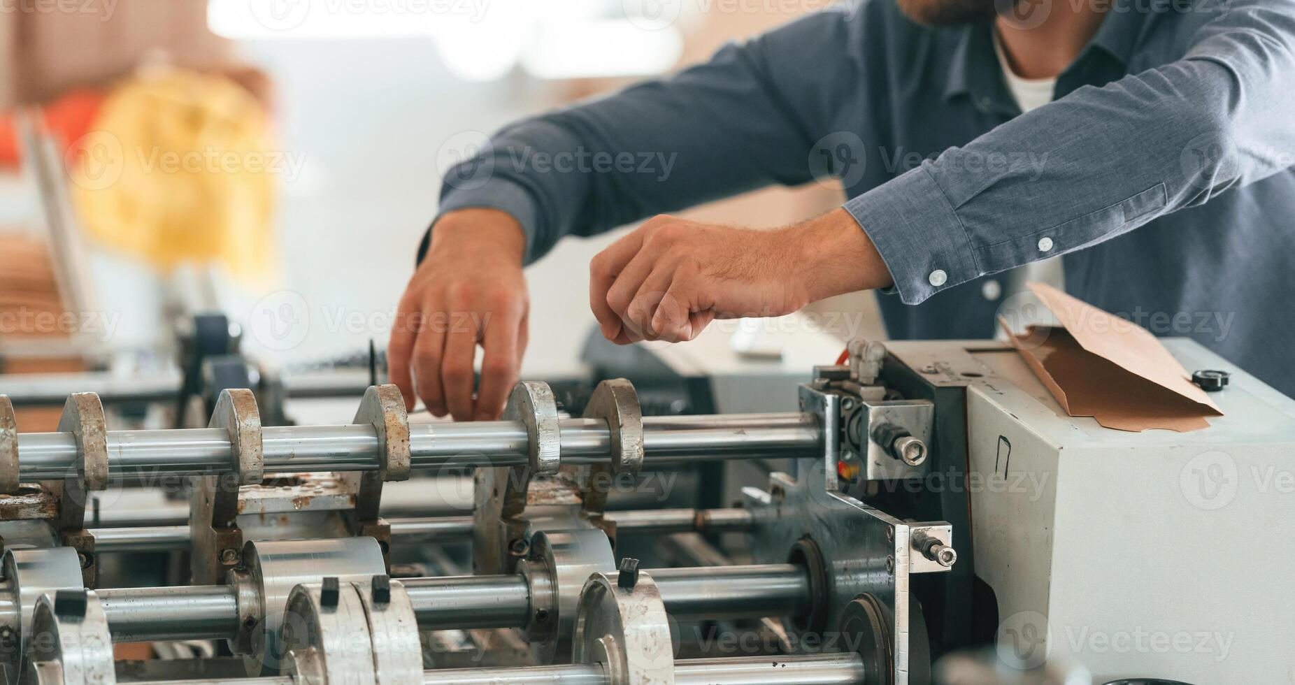Close up view. Man is working at the factory of creating eco boxes photo