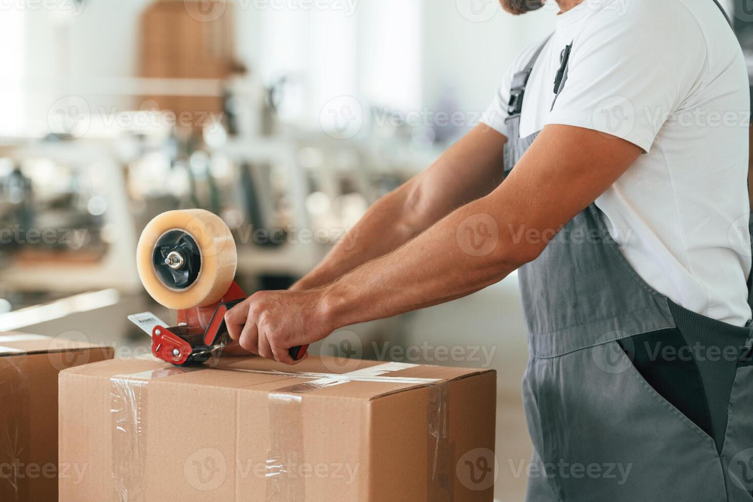Close, up ,view. Man is working at the factory of creating eco boxes photo