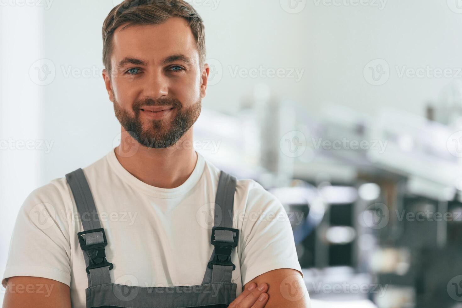 Close ,up portrait. Handsome man is working at the factory of creating eco boxes photo