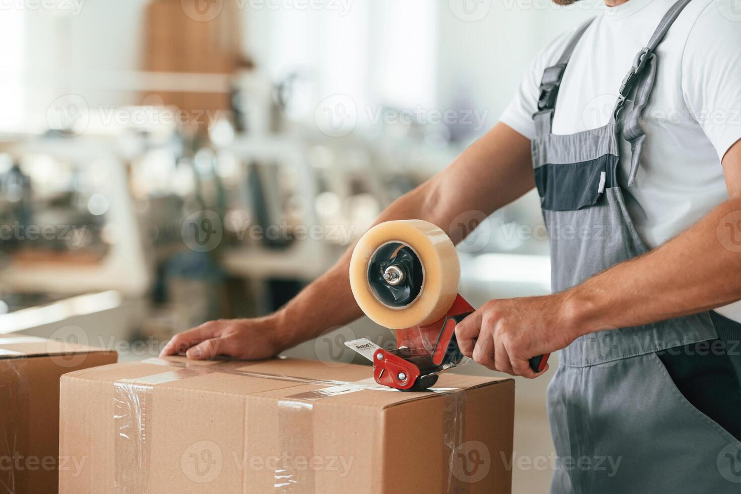 Close ,up ,,view. Man is working at the factory of creating eco boxes photo
