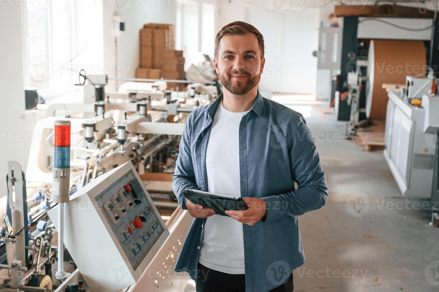 Single, employee.. Handsome man is working at the factory of creating eco boxes photo