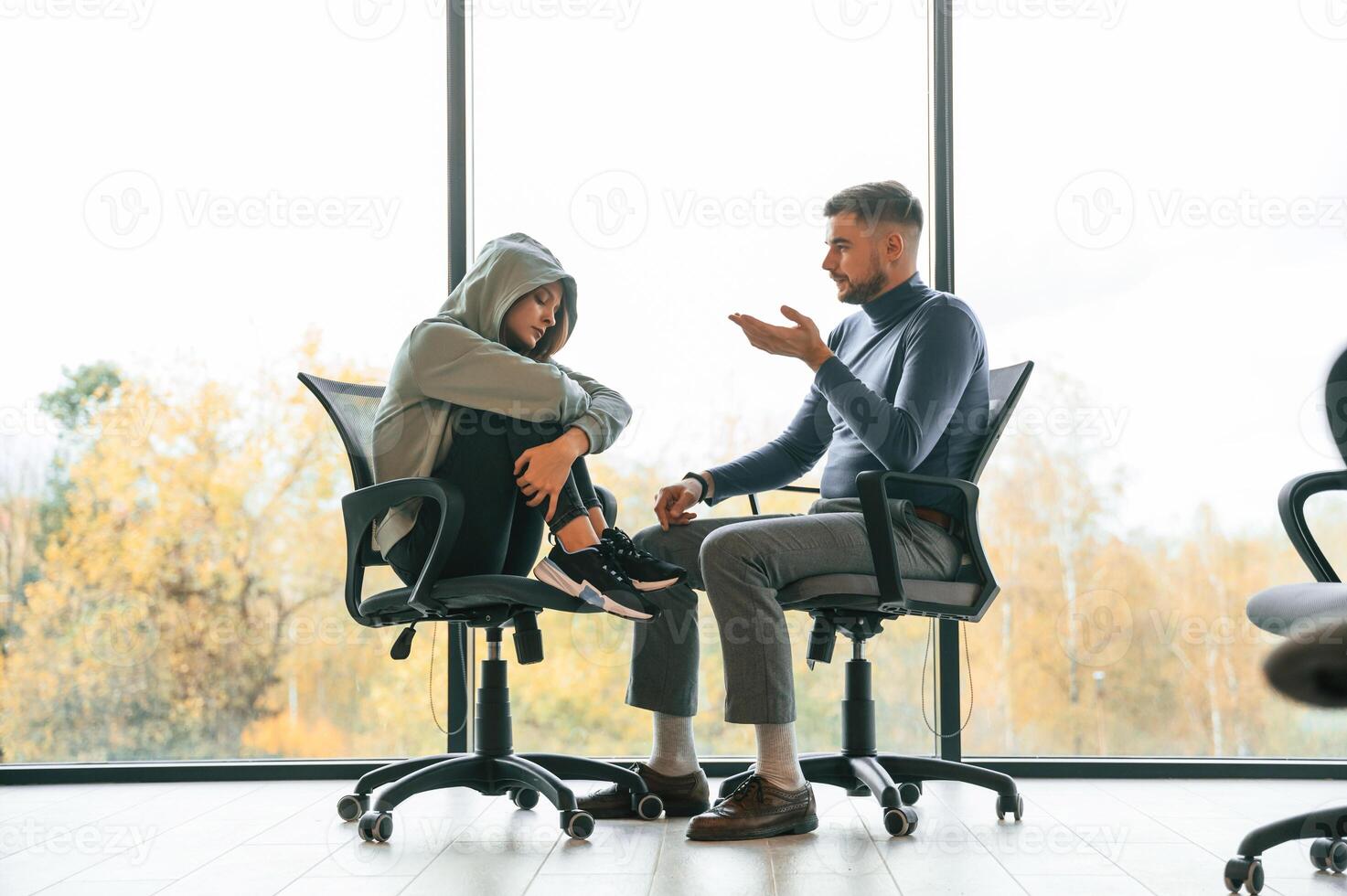 On the, chairs near window. Depressed woman is at an appointment with a psychologist photo