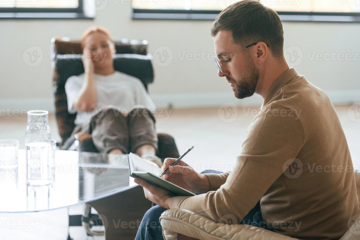 Life ,,problems. Woman is sitting in chair at an appointment with a psychologist photo