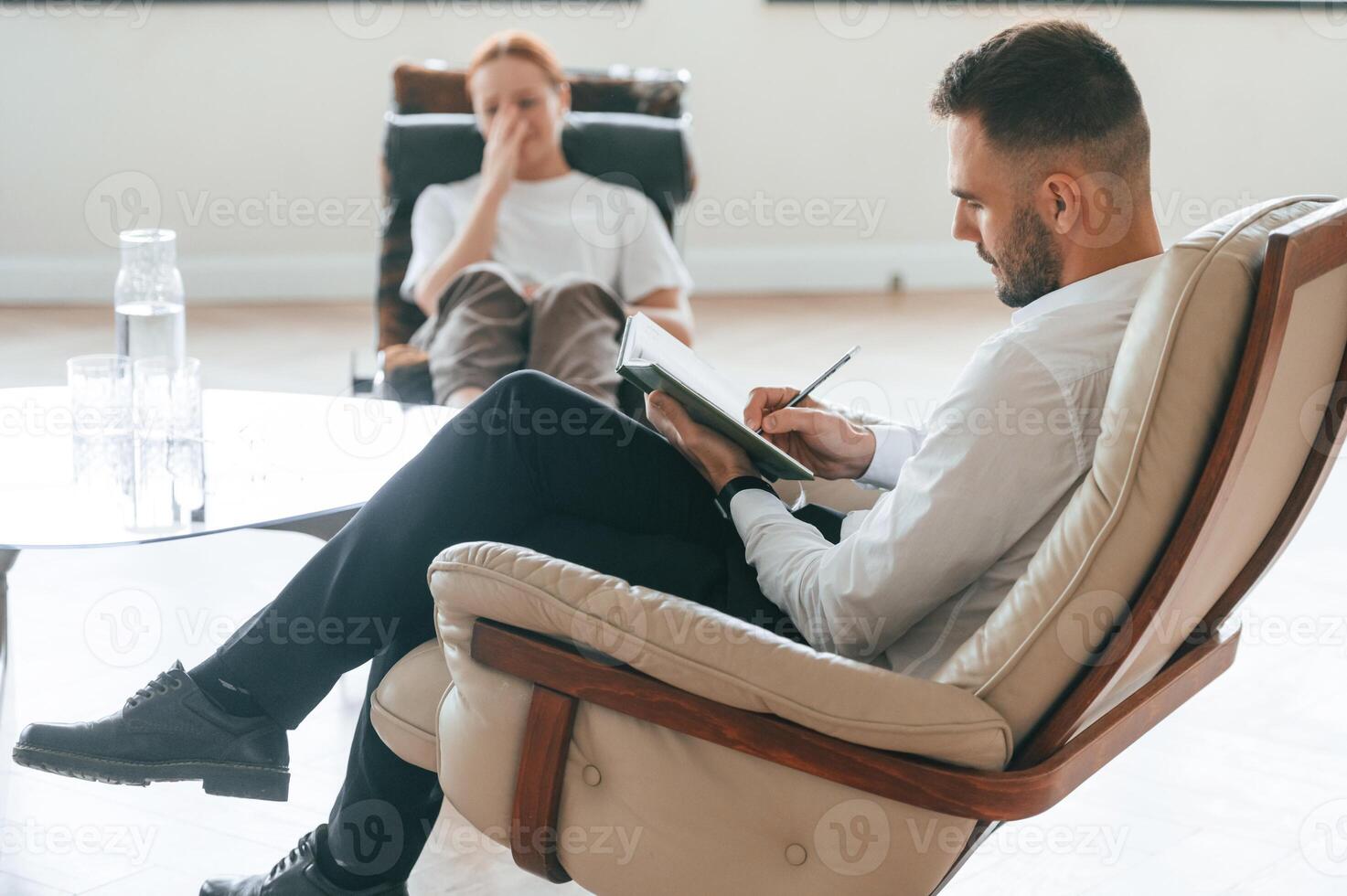 Life, problems. Woman, is sitting in chair at an appointment with a psychologist photo