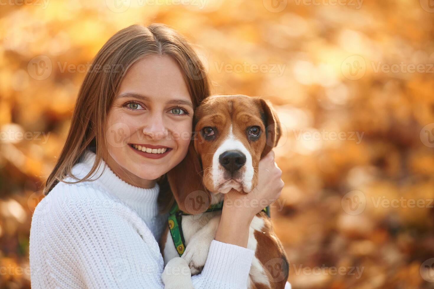 Close ,up portrait,, embracing animal. Woman is with her cute dog in the autumn forest photo