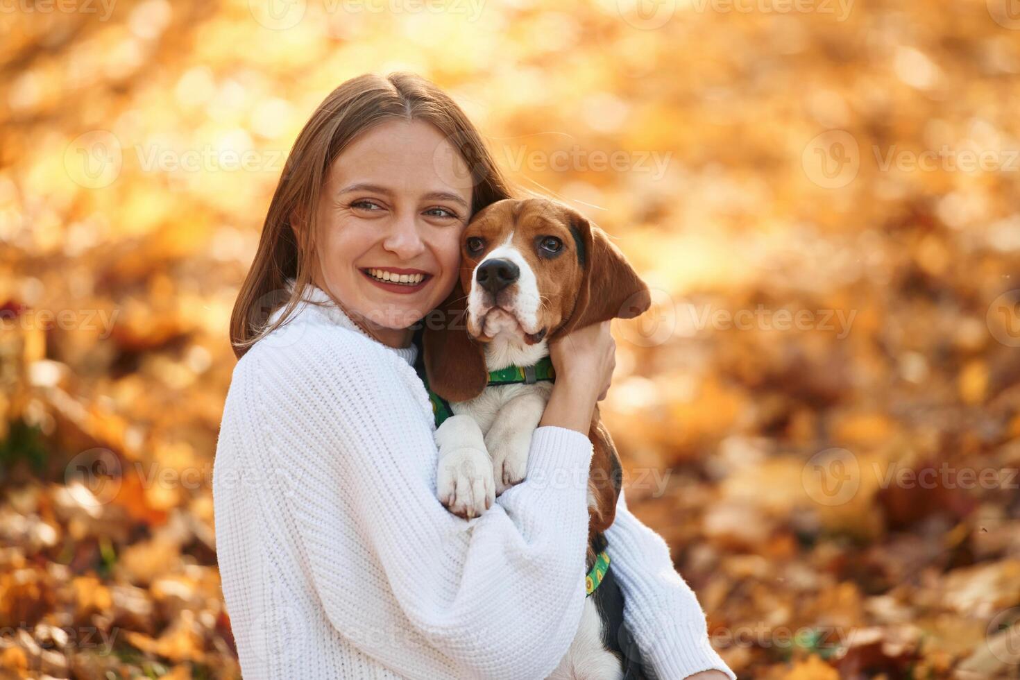 Close, up, portrait, embracing animal. Woman is with her cute dog in the autumn forest photo