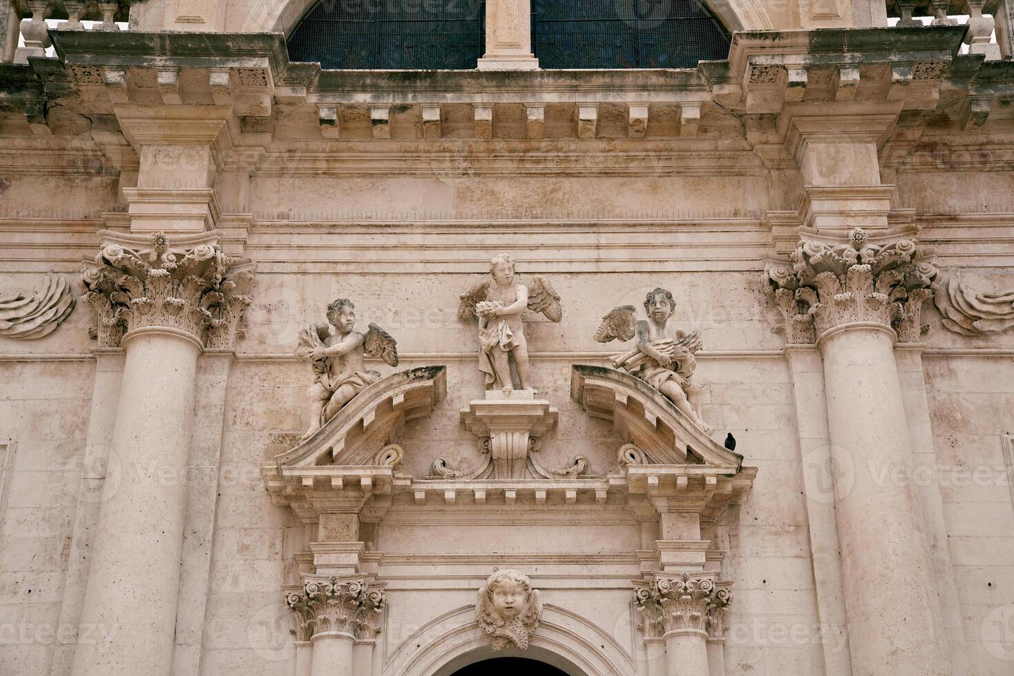 Statues of angels above the arched entrance of the Church of St. Blaise. Dubrovnik, Croatia photo
