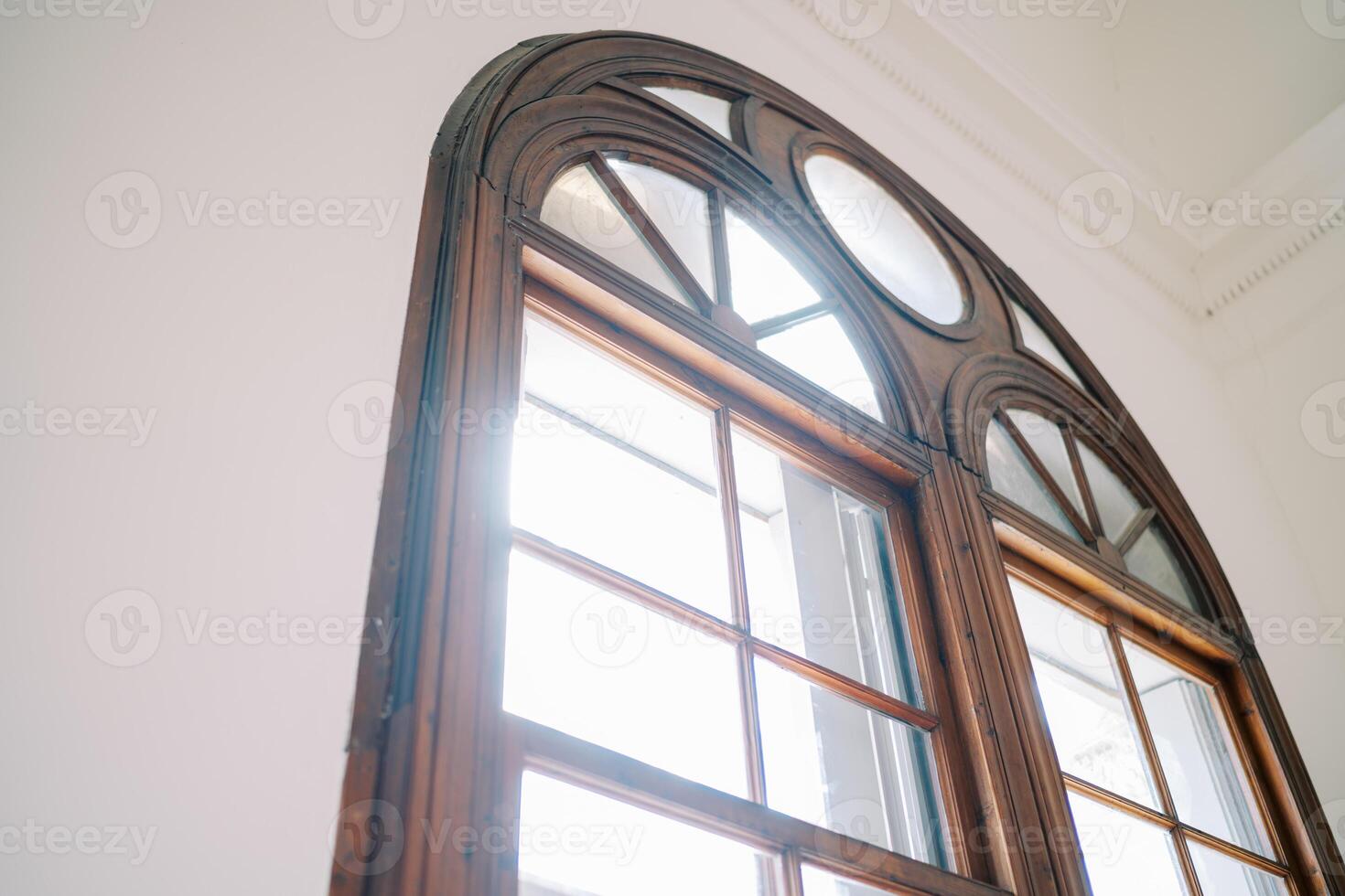 Arched wooden window in a room of an ancient villa photo
