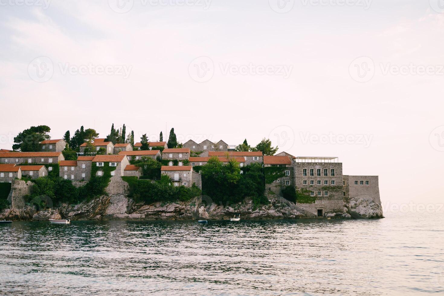 Old stone buildings with red roofs on the island of Sveti Stefan. Montenegro photo