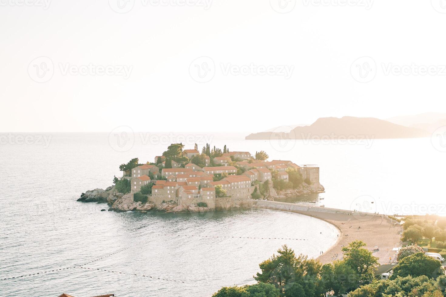 Sveti Stefan island with a beach on an isthmus in the Bay of Kotor. Montenegro photo