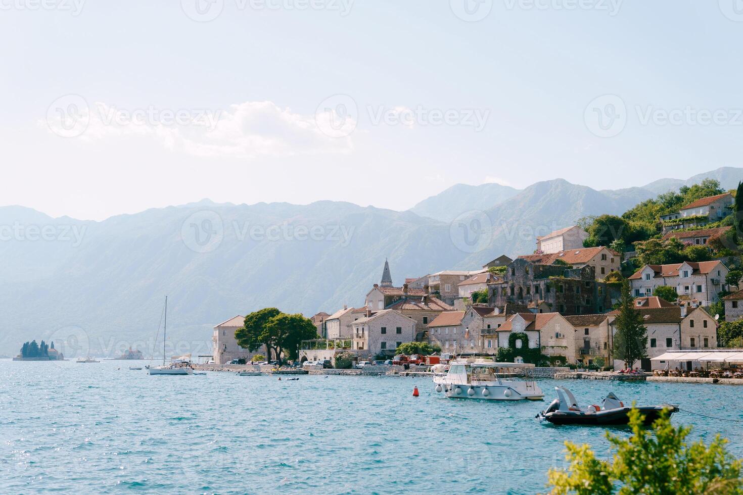 Excursion boats are moored off the coast of Perast against the backdrop of mountains. Montenegro photo