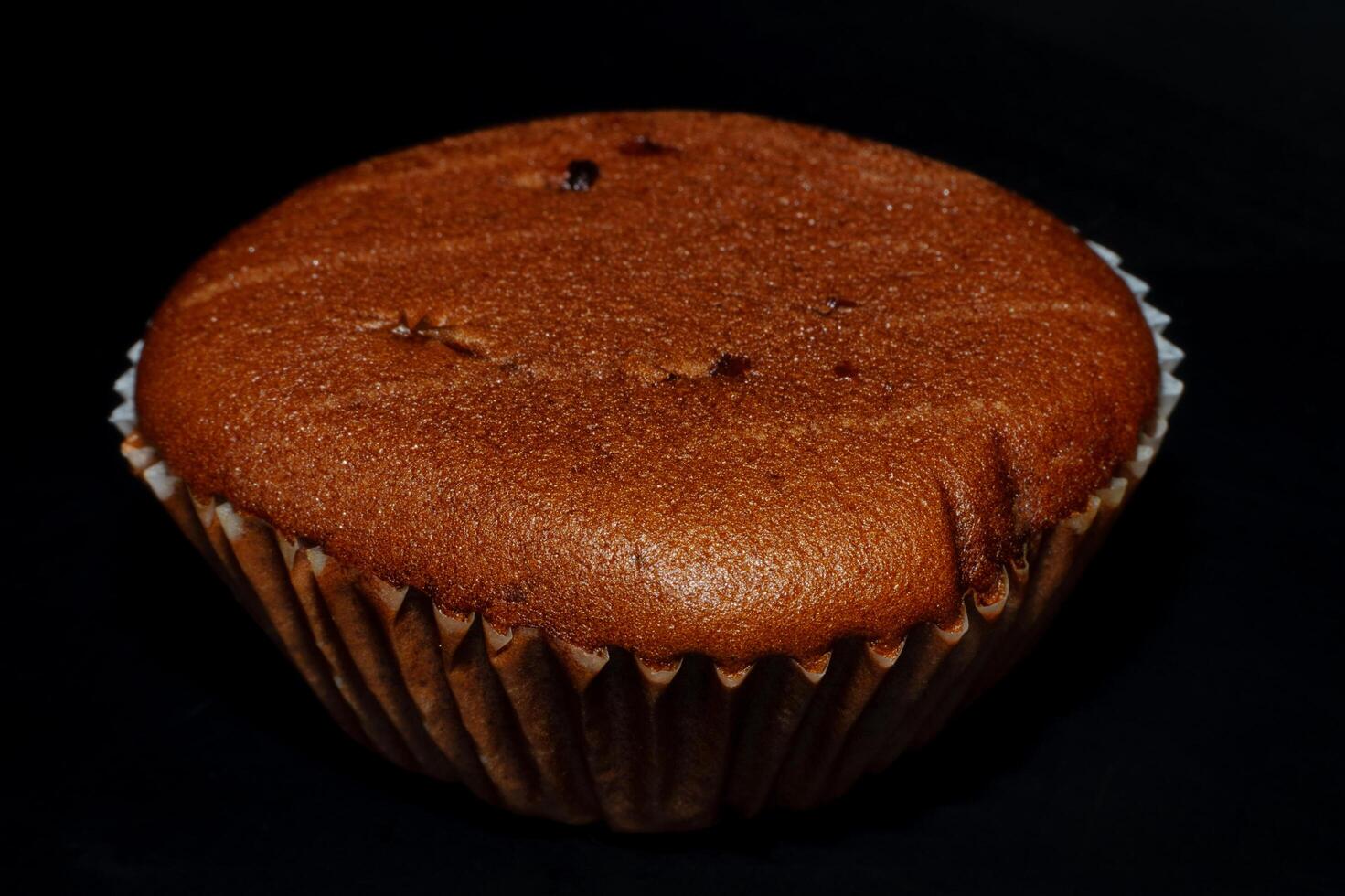 A cupcake is shown on a black background photo