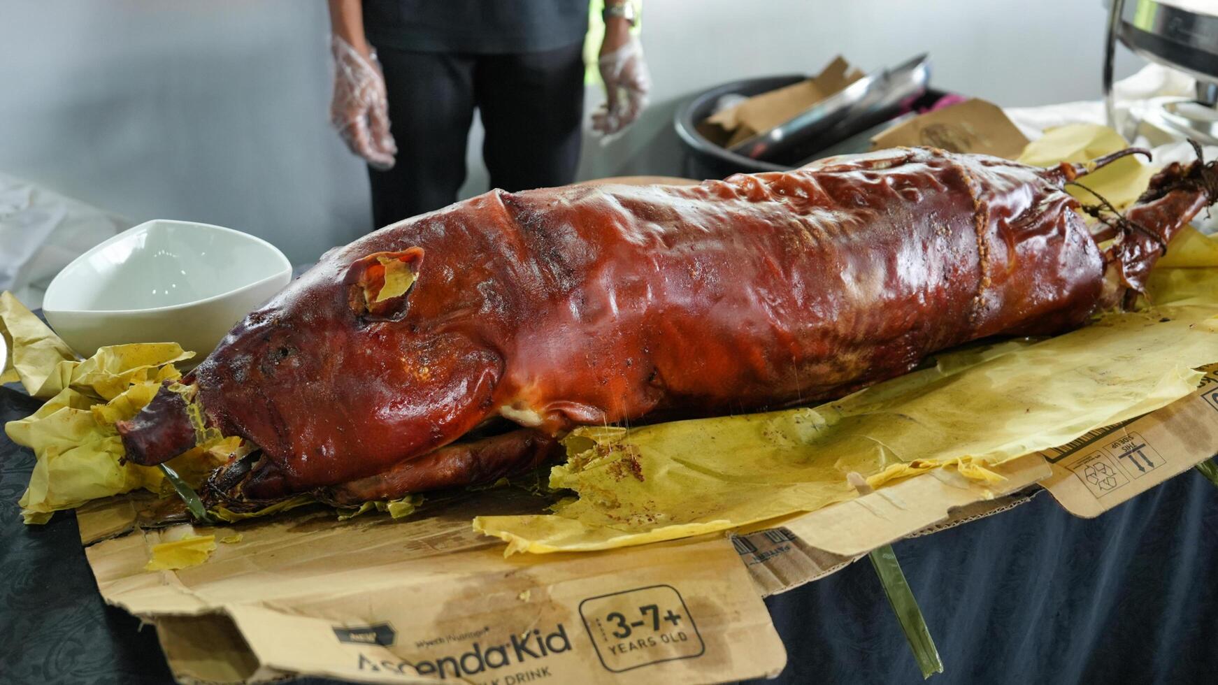 a large pig on a table with a knife photo