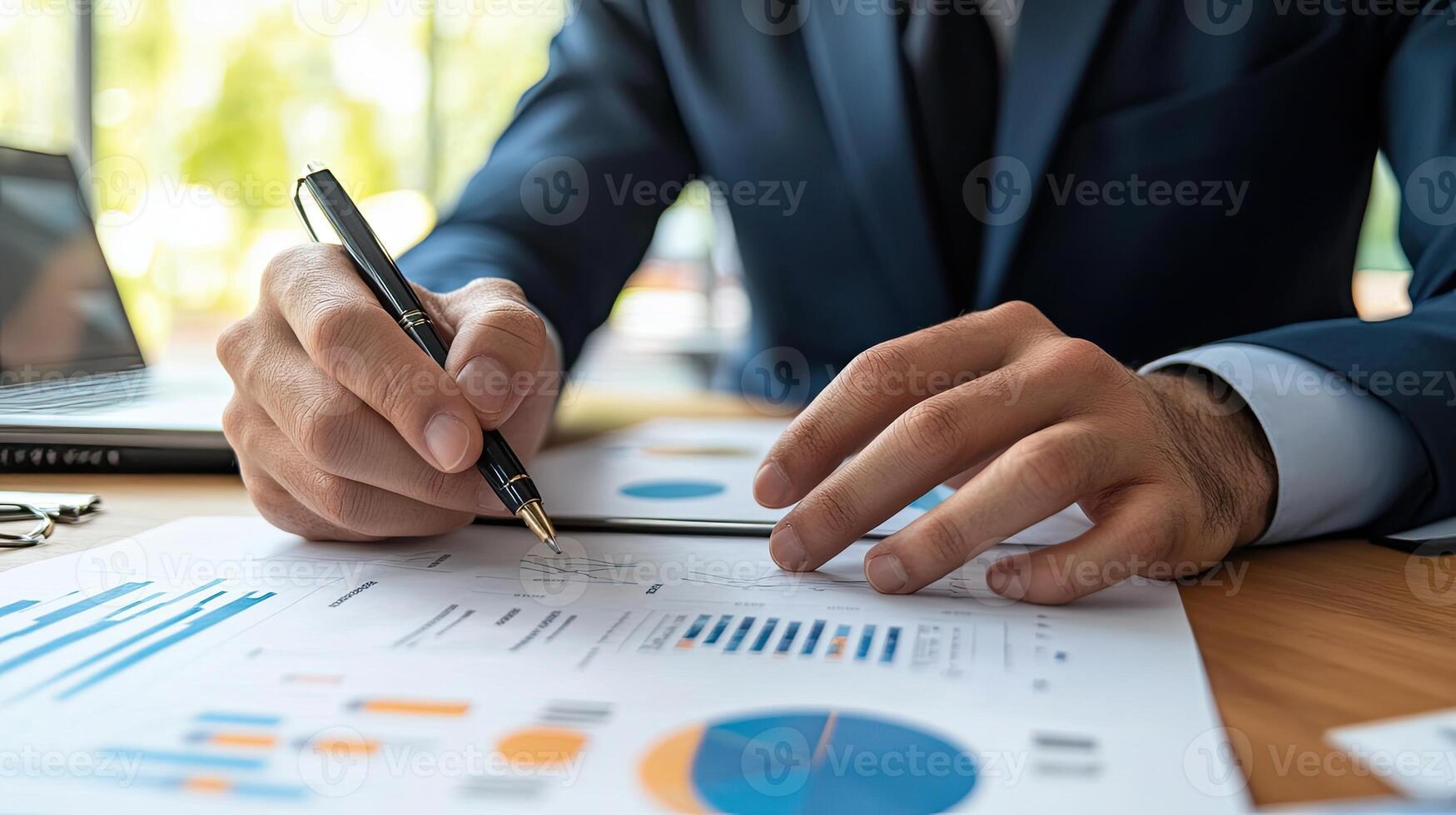 A man in a suit is writing on a piece of paper photo