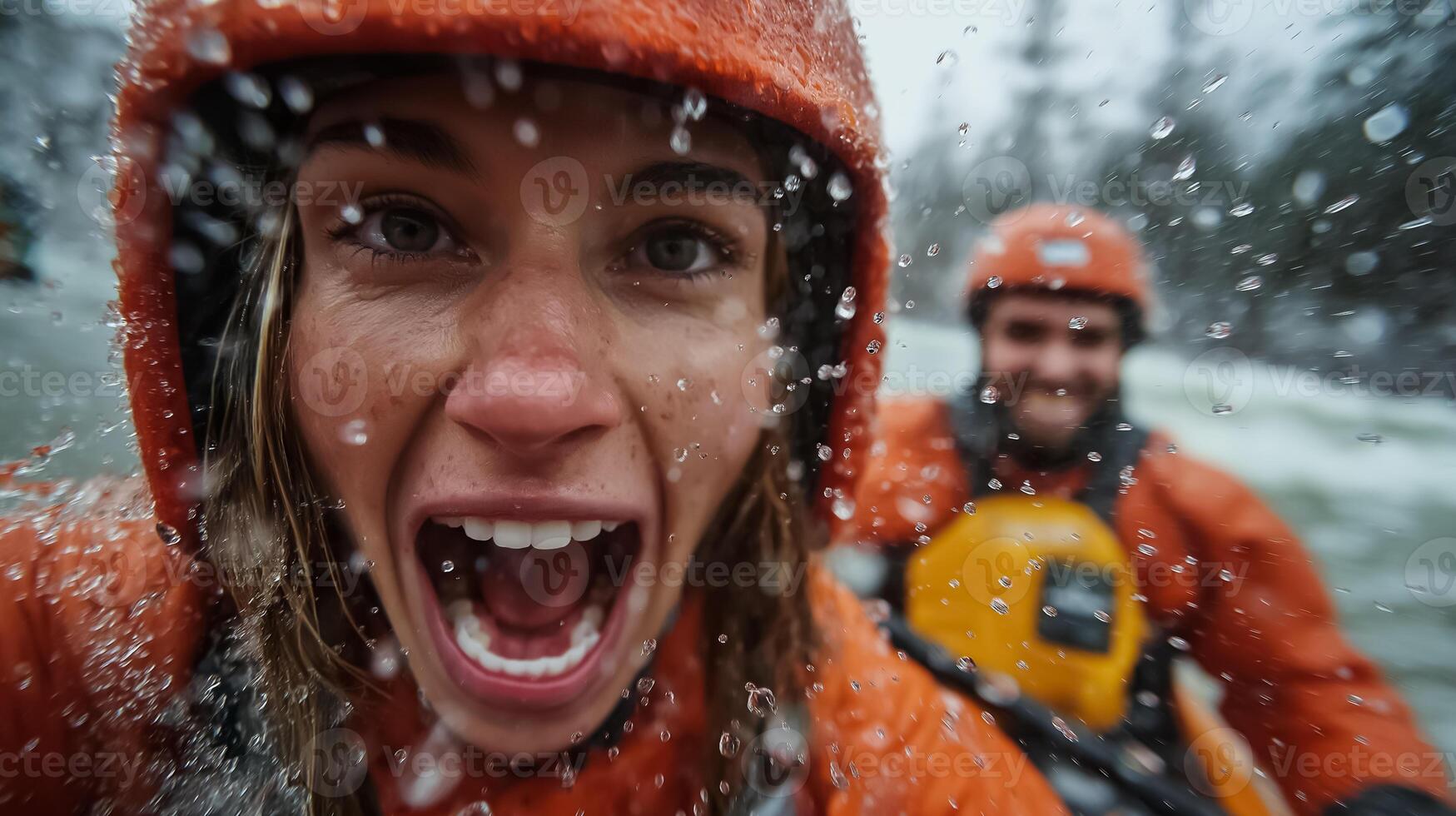 A woman in an orange rain jacket is smiling while riding a raft photo