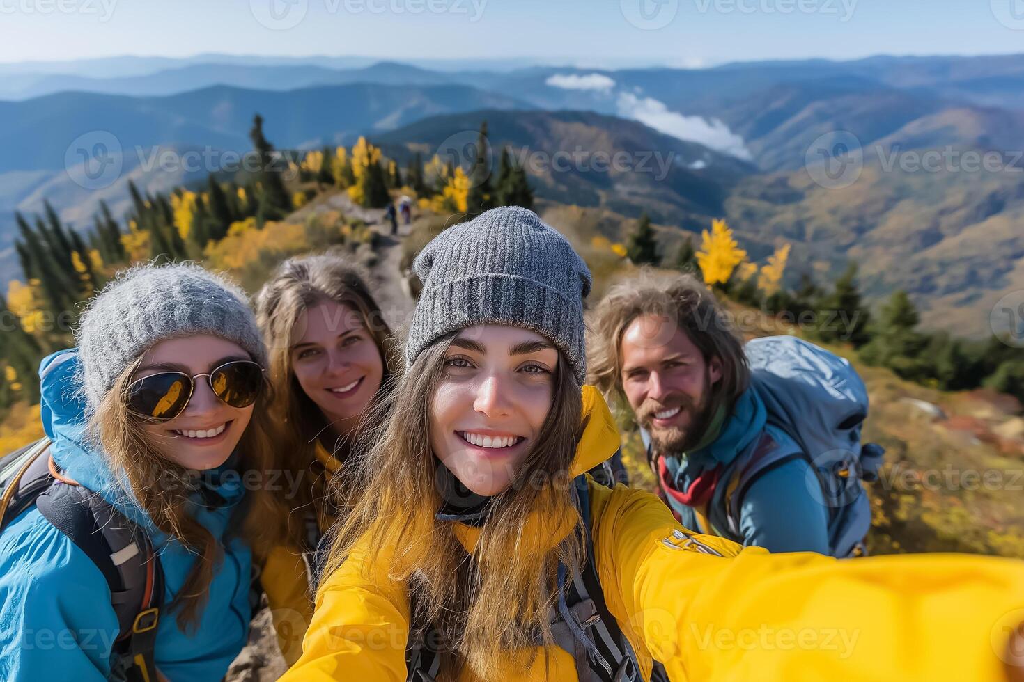 Four people taking a selfie on a mountain photo