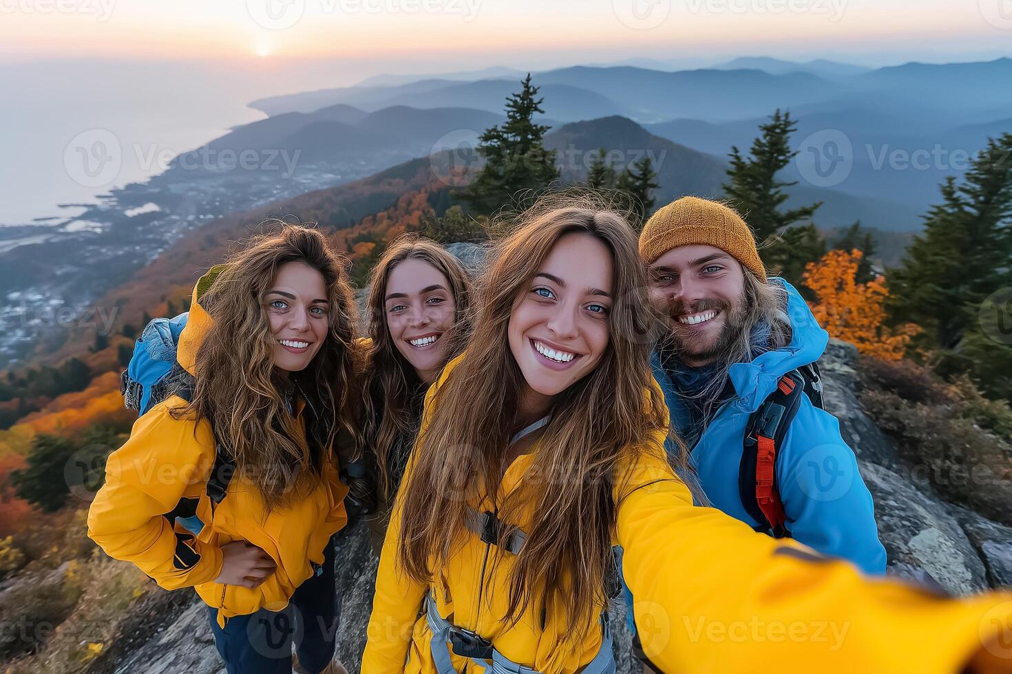 Four friends taking selfie on mountain top photo