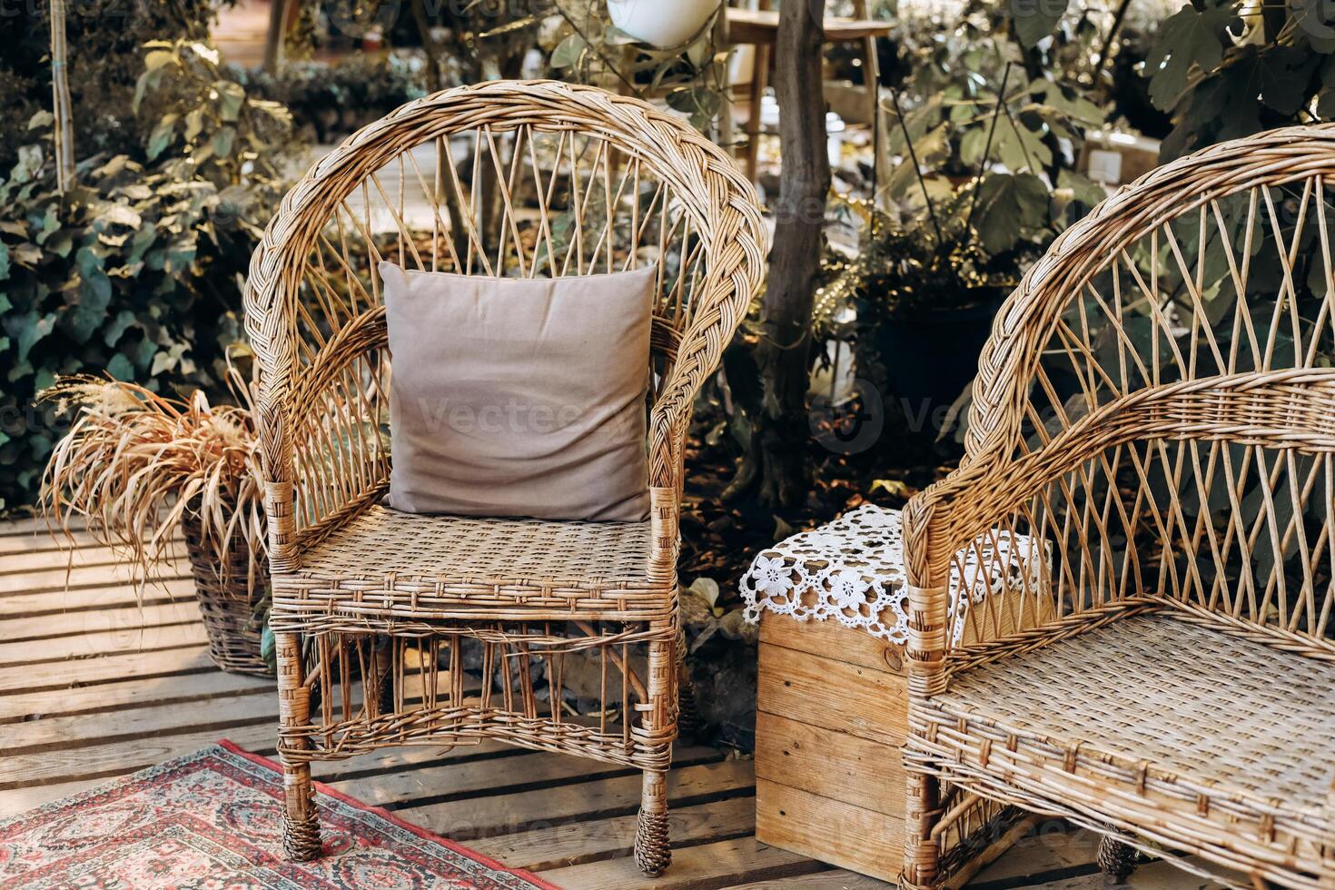 Cozy seating arrangement with rattan chairs in a garden setting during sunlight hours photo