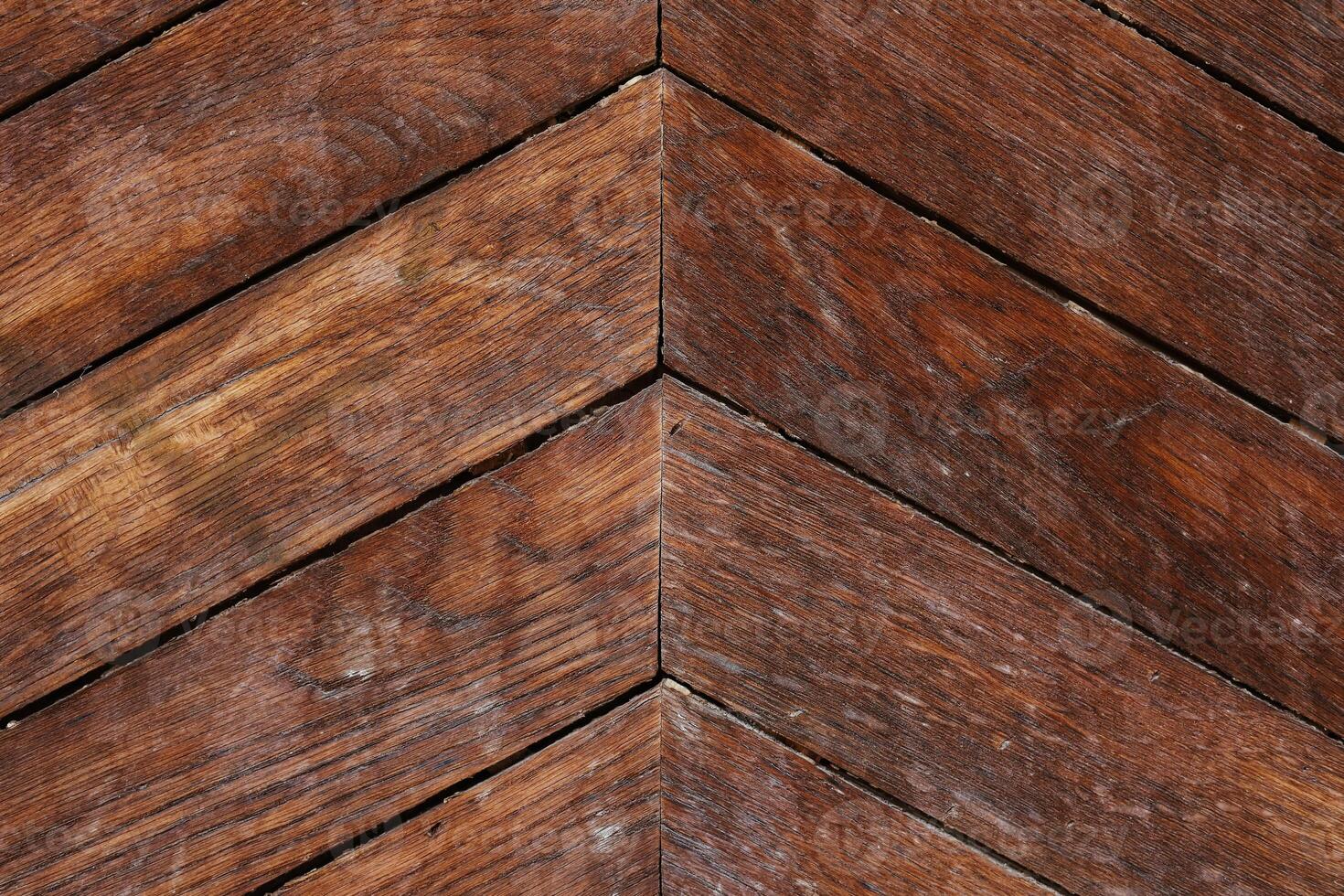 Decorative wooden floor with herringbone pattern seen in natural light photo