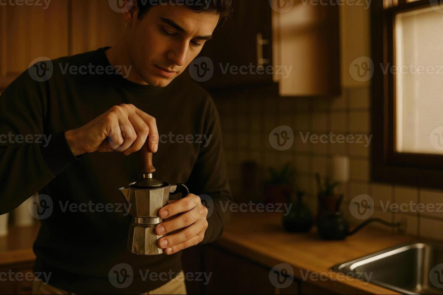 Man preparing coffee with moka pot in wooden kitchen photo
