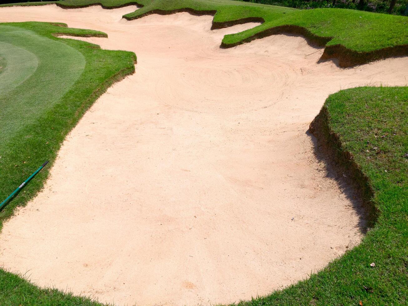 Freshly raked sand trap on golf course,showing clean texture and clear lines photo