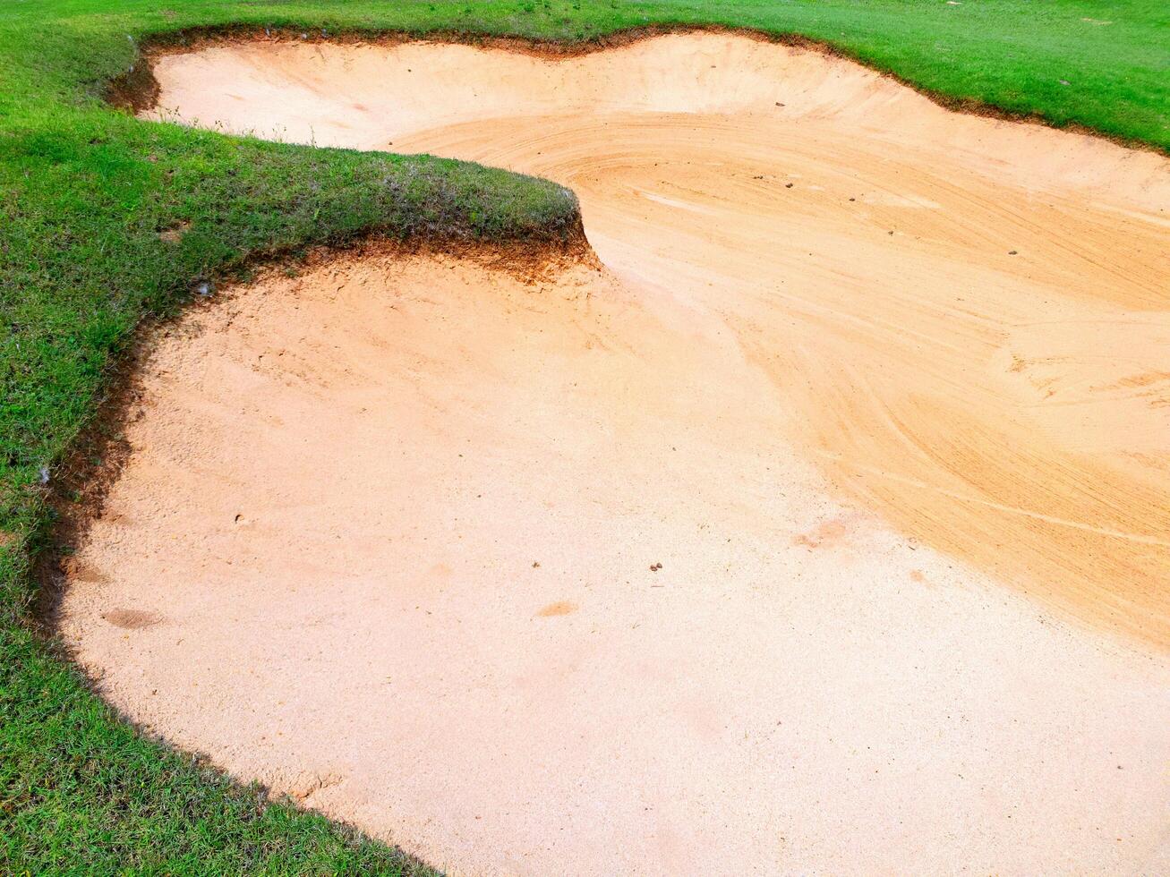 Freshly raked sand trap on golf course, showing clean texture and clear lines photo