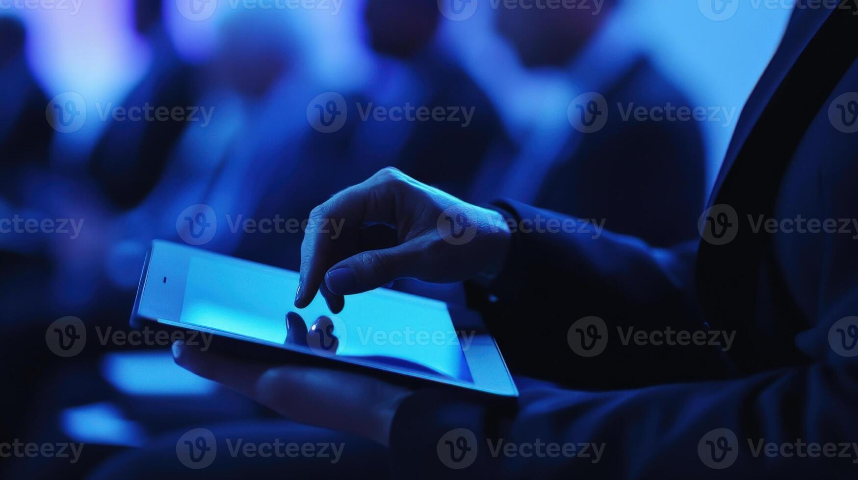 In a closeup an interpreter leans forward fingers poised over a tablet capturing key points from a speakers presentation. The interpreters expression reflects concentration and photo