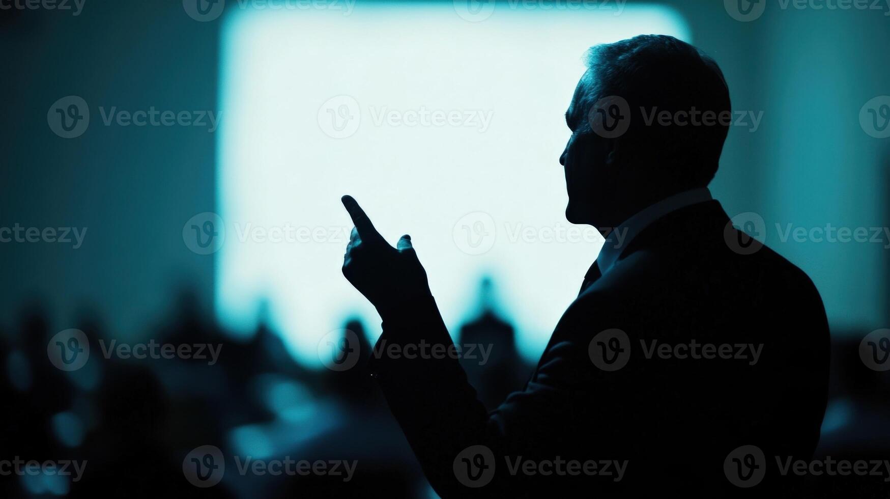 Captured midsentence a diplomat exudes confidence as they present their viewpoint hands elevated for emphasis. The softly defocused backdrop reveals a gathering of international photo