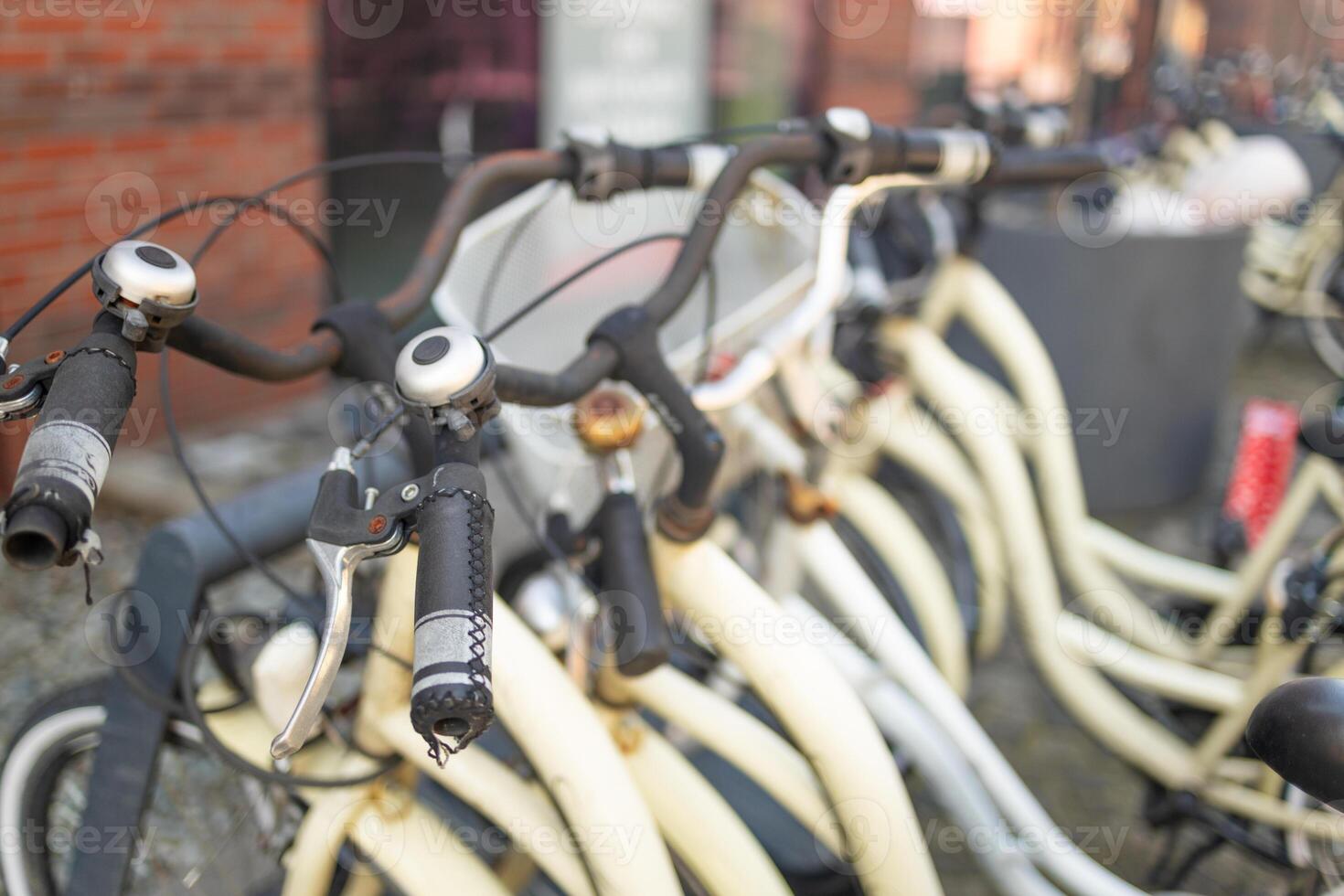 Close-up of bicycle handlebars in an urban bike-sharing station photo