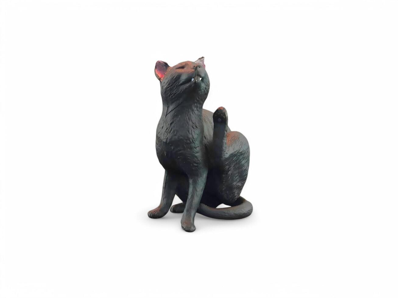 A black cat statue sitting on a white background photo