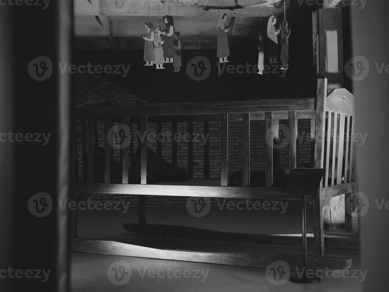 An Eerie Attic Scene Featuring Hanging Doll Figures Rendered in Monochrome Tones photo