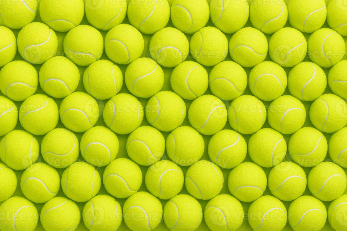 Bright yellow tennis balls arranged tightly in rows, creating a dynamic and sporty texture ideal for backgrounds, advertising, tennis promotions, or design templates photo