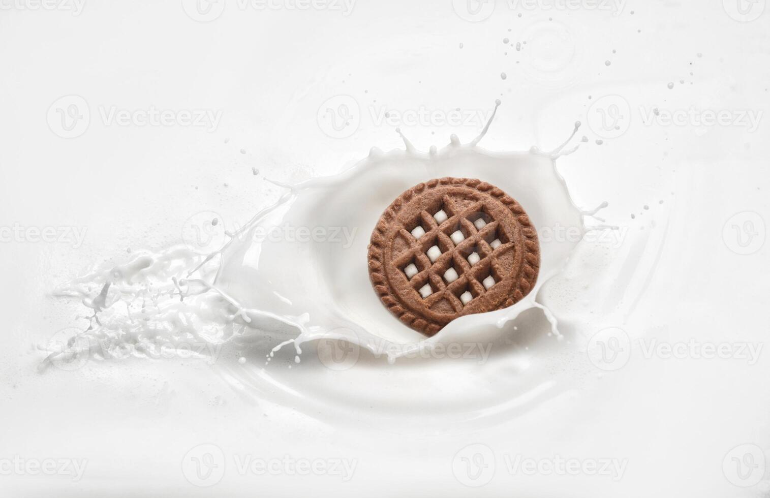 Cookies in milk with a splash photo