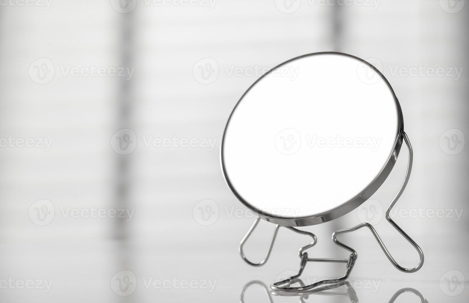 A mirror on a table with a white background photo