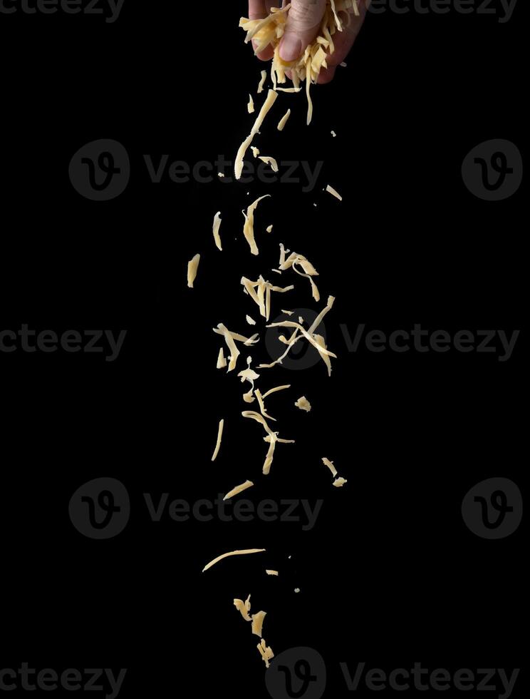 Shredded cheese on a black background photo