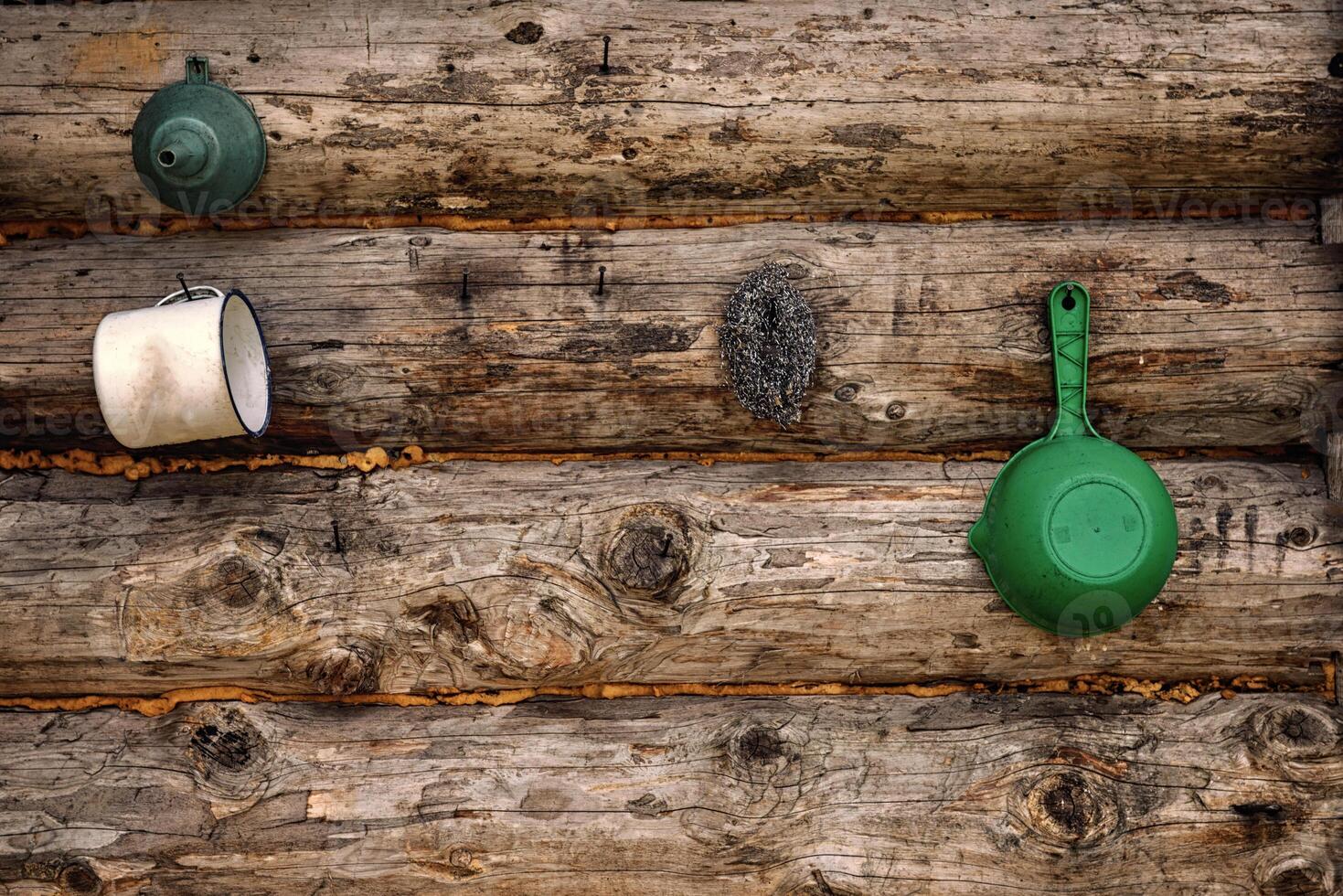 A wooden wall with a green and white mug hanging on it photo