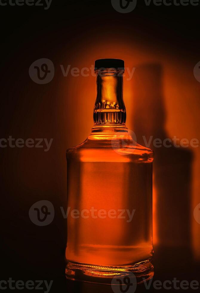 Whiskey bottle on dark background photo