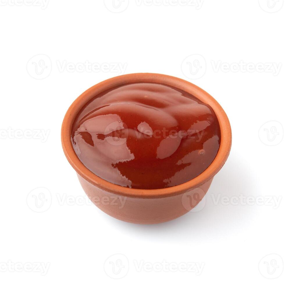 Gravy boat with ketchup on isolated background photo