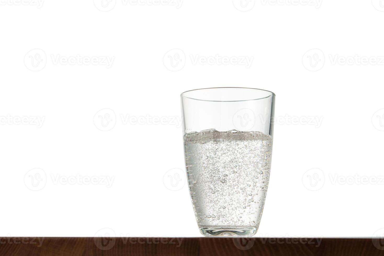 Glass of water on table with isolated background photo