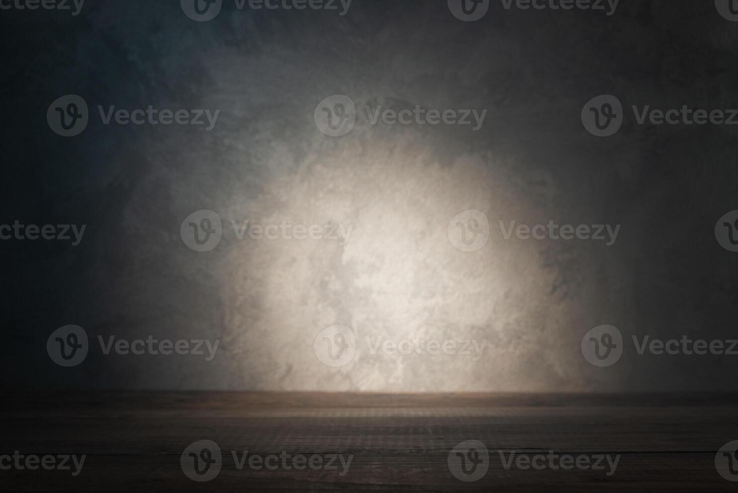 Table top on background of concrete wall with ray of light photo