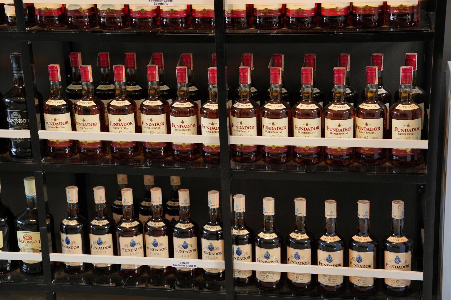 a shelf full of bottles of alcohol photo