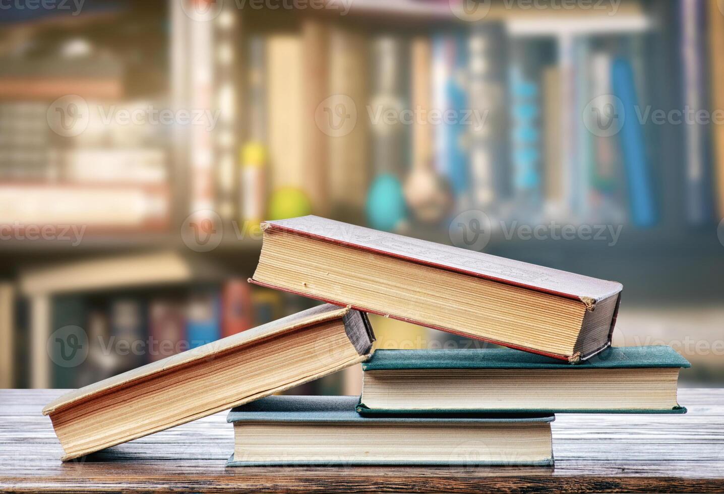 Stack of books on a wooden table photo