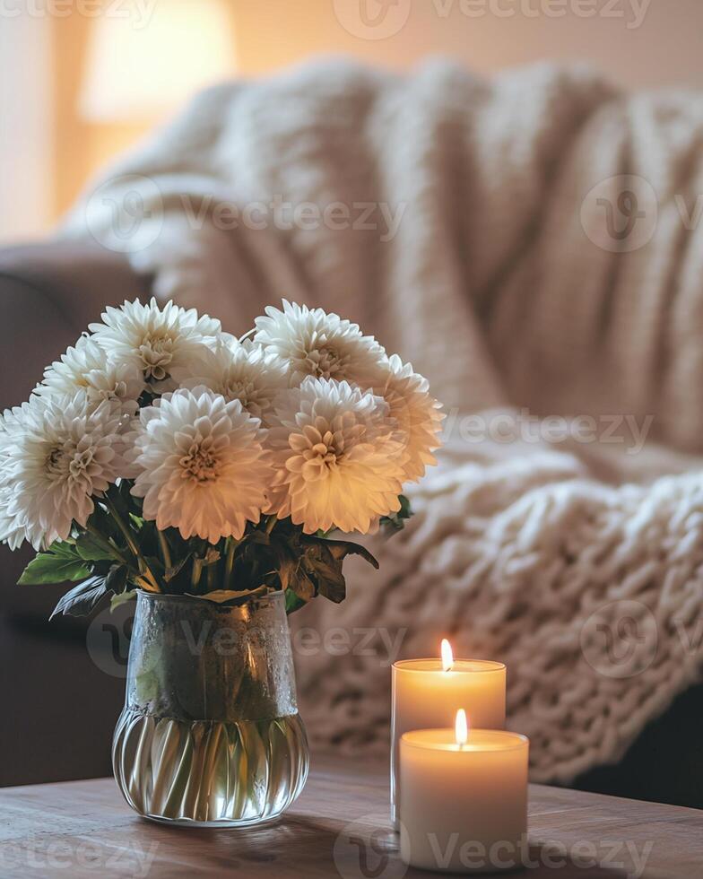 White Dahlias, Candles, and Knit Throw on Wooden Table photo