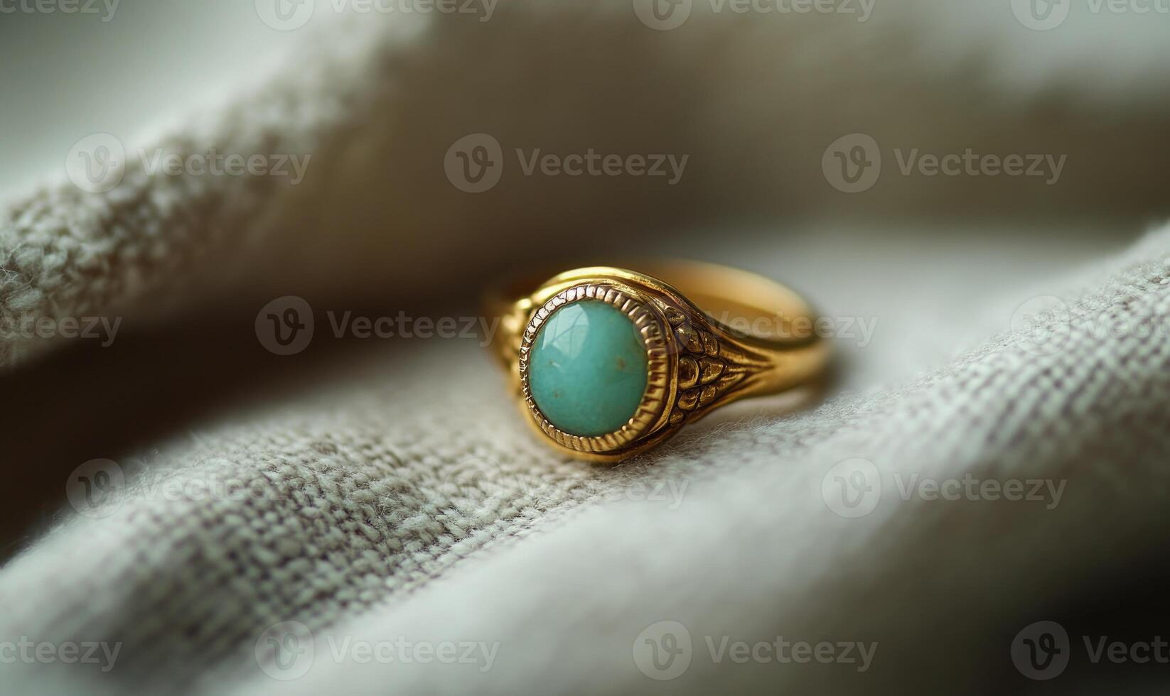 a gold ring with a turquoise stone on it photo